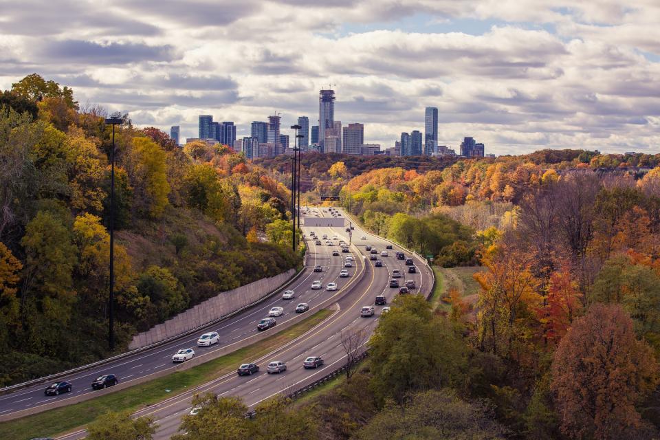 Multi-lane highway leading toward a city skyline